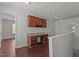 Upstairs landing with custom built-in desk and cabinetry on hardwood floors at 1928 Grace Point Rd, Morrisville, NC 27560