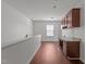 Open upstairs landing with desk, cabinets, hardwood floors, and natural light at 1928 Grace Point Rd, Morrisville, NC 27560