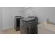 Modern laundry room with side-by-side washer and dryer plus a sink with amenities at 1928 Grace Point Rd, Morrisville, NC 27560