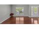 Bright room with hardwood floors, large window, and a single door with wood trim at 1928 Grace Point Rd, Morrisville, NC 27560