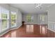 Inviting living room features large windows allowing natural light and beautiful hardwood floors at 1928 Grace Point Rd, Morrisville, NC 27560