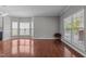 Open living space showcasing hardwood floors and multiple windows offering plenty of natural light at 1928 Grace Point Rd, Morrisville, NC 27560