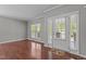 Spacious living room showcasing hardwood floors, natural light, and a door leading to the exterior at 1928 Grace Point Rd, Morrisville, NC 27560