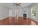 Bright living room featuring hardwood floors, a fireplace, and plenty of natural light at 1928 Grace Point Rd, Morrisville, NC 27560