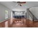 Open floor plan showcasing a spacious living room with hardwood floors, staircase, and kitchen view at 1928 Grace Point Rd, Morrisville, NC 27560