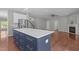 Spacious living area showing a kitchen island, fireplace, and hardwood floors for a modern style at 1928 Grace Point Rd, Morrisville, NC 27560