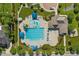 Aerial view of a community pool with clear blue water, lounge chairs, umbrellas, and a slide, providing an ideal recreational space at 1928 Grace Point Rd, Morrisville, NC 27560