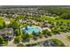Aerial view of a neighborhood pool and clubhouse surrounded by lush landscaping and community homes on a sunny day at 1928 Grace Point Rd, Morrisville, NC 27560