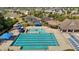 Aerial view of a community pool with clear blue water, lounge chairs, umbrellas, and a slide, providing an ideal recreational space at 1928 Grace Point Rd, Morrisville, NC 27560