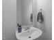 The powder room has a pedestal sink, stylish fixtures, and a decorative hand towel at 1928 Grace Point Rd, Morrisville, NC 27560