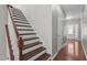 Staircase features wooden stairs, white risers, and access to the upper level at 1928 Grace Point Rd, Morrisville, NC 27560