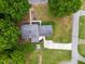 Overhead view of a home featuring lush greenery, a well-maintained yard, and a long driveway at 2021 Sunnybrook Dr, Burlington, NC 27215