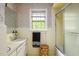 Bathroom with retro floral wallpaper, yellow tile, and a shower-tub combo at 2021 Sunnybrook Dr, Burlington, NC 27215