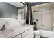 Full bathroom featuring a double vanity, shower-tub combo, and white tile at 2021 Sunnybrook Dr, Burlington, NC 27215