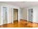 Open bedroom with beautiful hardwood floors, closet, and multiple doors at 2021 Sunnybrook Dr, Burlington, NC 27215