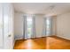 Bedroom with hardwood floors, two windows and light gray curtains at 2021 Sunnybrook Dr, Burlington, NC 27215