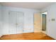 Bedroom featuring hardwood flooring, closet, and doorway to another room at 2021 Sunnybrook Dr, Burlington, NC 27215
