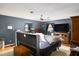 Cozy bedroom with hardwood floors, ceiling fan, and two windows with natural light at 2021 Sunnybrook Dr, Burlington, NC 27215