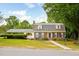 Charming brick home with manicured lawn and mature trees under a blue sky at 2021 Sunnybrook Dr, Burlington, NC 27215