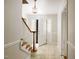 Inviting foyer with staircase and stylish light fixture adds charm at 2021 Sunnybrook Dr, Burlington, NC 27215
