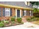 Charming brick home with dark shutters, a beautiful entryway, and landscaping at 2021 Sunnybrook Dr, Burlington, NC 27215