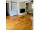 Bright living room with hardwood floors and a charming fireplace at 2021 Sunnybrook Dr, Burlington, NC 27215