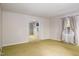 Bright and airy living room with carpet, neutral walls and doorway to another room at 2021 Sunnybrook Dr, Burlington, NC 27215