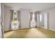 Living room with carpet, two windows and a doorway at 2021 Sunnybrook Dr, Burlington, NC 27215