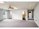 Spacious living room featuring ceiling fan, neutral walls, and entrances to multiple rooms at 2021 Sunnybrook Dr, Burlington, NC 27215