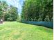 Lush green backyard with privacy fence and mature trees at 2100 Possum Trot Rd, Wake Forest, NC 27587