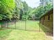 Spacious grassy backyard enclosed by a wrought iron fence at 2100 Possum Trot Rd, Wake Forest, NC 27587