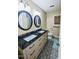 Modern bathroom featuring a double vanity with black countertop and patterned floor at 2100 Possum Trot Rd, Wake Forest, NC 27587