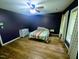 Bedroom with a ceiling fan, wood floors, and a colorful striped bedspread at 2100 Possum Trot Rd, Wake Forest, NC 27587