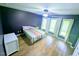 Bedroom featuring wood floors, large windows, and ceiling fan at 2100 Possum Trot Rd, Wake Forest, NC 27587