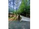 Long driveway leading to a home surrounded by lush trees and landscaping at 2100 Possum Trot Rd, Wake Forest, NC 27587