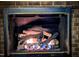 Close-up of the fireplace, featuring lit gas logs at 2100 Possum Trot Rd, Wake Forest, NC 27587
