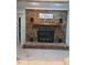 Close-up of the brick fireplace in the living room with mantel and hearth at 2100 Possum Trot Rd, Wake Forest, NC 27587