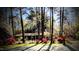 Charming home surrounded by mature trees and flowering shrubs in the front yard at 2100 Possum Trot Rd, Wake Forest, NC 27587