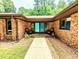Inviting brick front porch with double doors, chairs, and a well-manicured walkway at 2100 Possum Trot Rd, Wake Forest, NC 27587