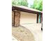 Attached two-car garage with brick veneer and concrete driveway at 2100 Possum Trot Rd, Wake Forest, NC 27587