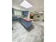 Bright kitchen featuring blue cabinets, farmhouse sink, an island with breakfast bar, and brick-laid flooring at 2100 Possum Trot Rd, Wake Forest, NC 27587