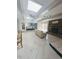 Open-concept living area featuring herringbone floors, brick fireplace, and seamless flow into the kitchen at 2100 Possum Trot Rd, Wake Forest, NC 27587