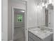 Bathroom featuring a granite countertop vanity, with a view into the carpeted bedroom at 2222 Oak Ridge Blvd, Durham, NC 27707