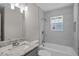 Well-lit bathroom features tiled shower/tub combo and granite vanity at 2222 Oak Ridge Blvd, Durham, NC 27707