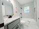 Modern bathroom with granite vanity, tub, and gray tile at 2222 Oak Ridge Blvd, Durham, NC 27707