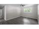 Spacious bedroom features hardwood floors, a ceiling fan, and natural lighting at 2222 Oak Ridge Blvd, Durham, NC 27707