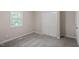 Bedroom with neutral walls and carpet, featuring a double door closet and window at 2222 Oak Ridge Blvd, Durham, NC 27707