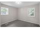 Carpeted bedroom with two windows providing ample natural light at 2222 Oak Ridge Blvd, Durham, NC 27707