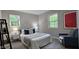Cozy bedroom with ample natural light, neutral walls, and a comfortable bed at 2222 Oak Ridge Blvd, Durham, NC 27707