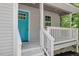 Charming front porch with a bright blue door, gray siding, and a white railing at 2222 Oak Ridge Blvd, Durham, NC 27707